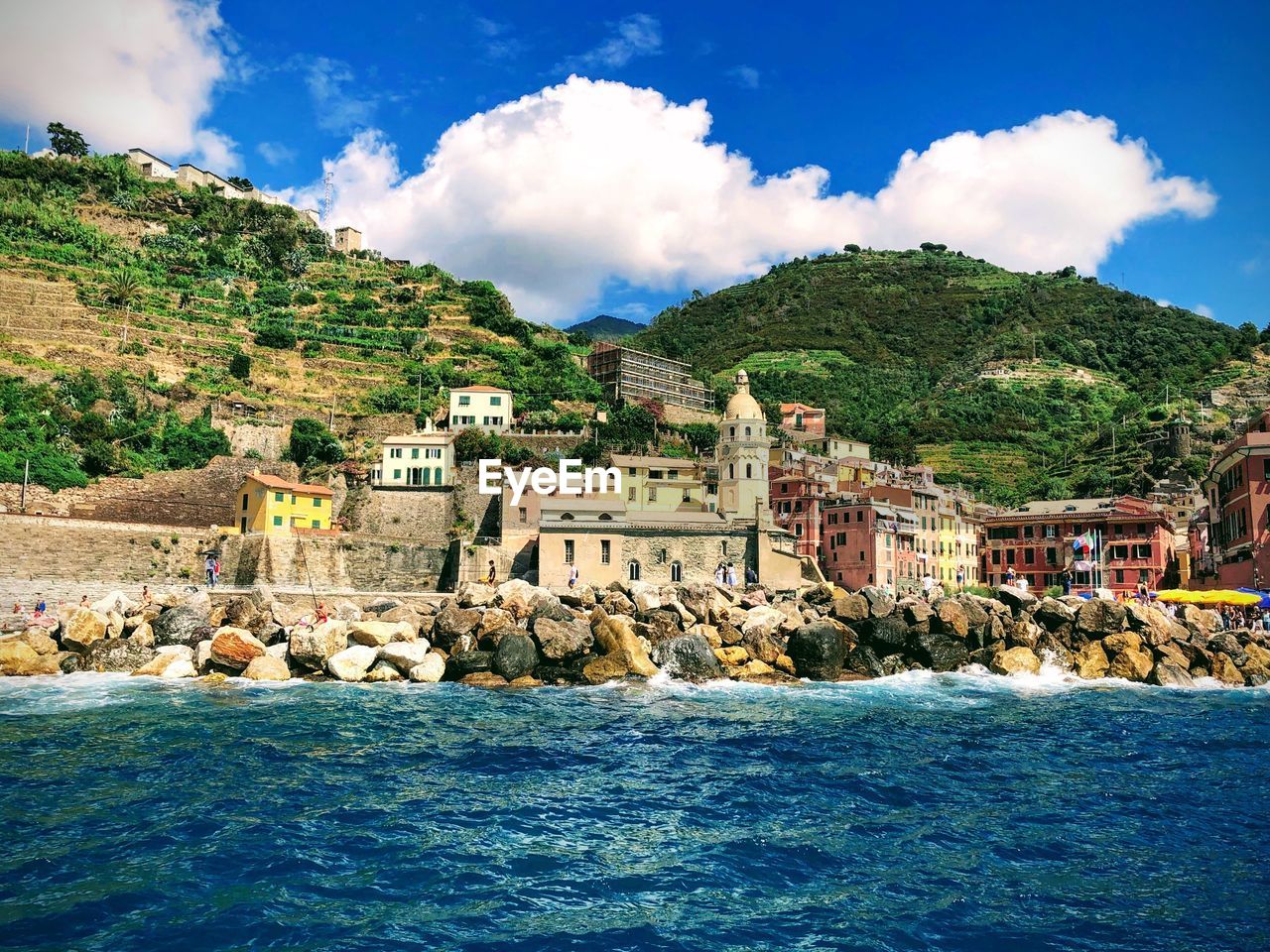 Scenic view of sea by buildings against sky