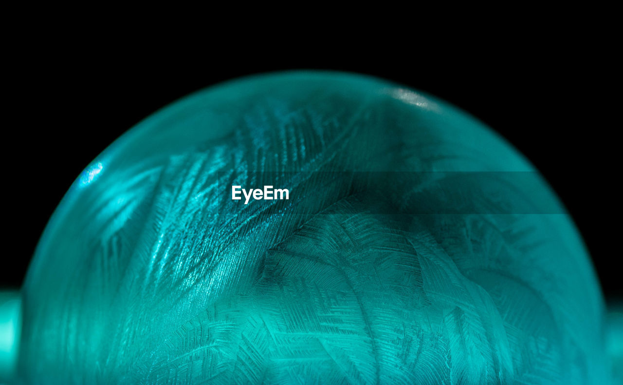 Close-up of crystal ball against black background