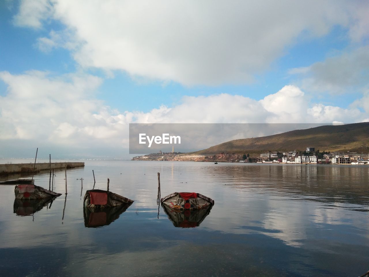 Boats moored on sea against sky