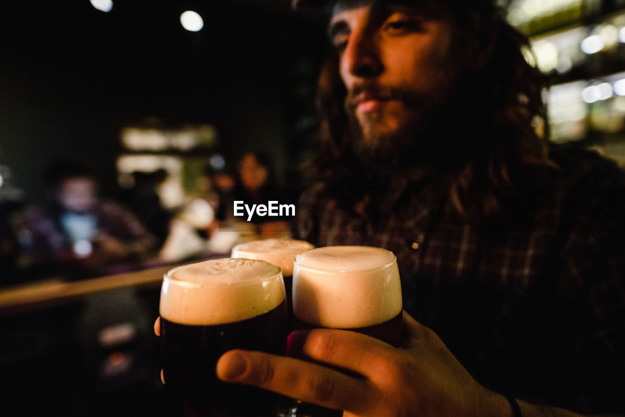 Bartender holding beer glasses