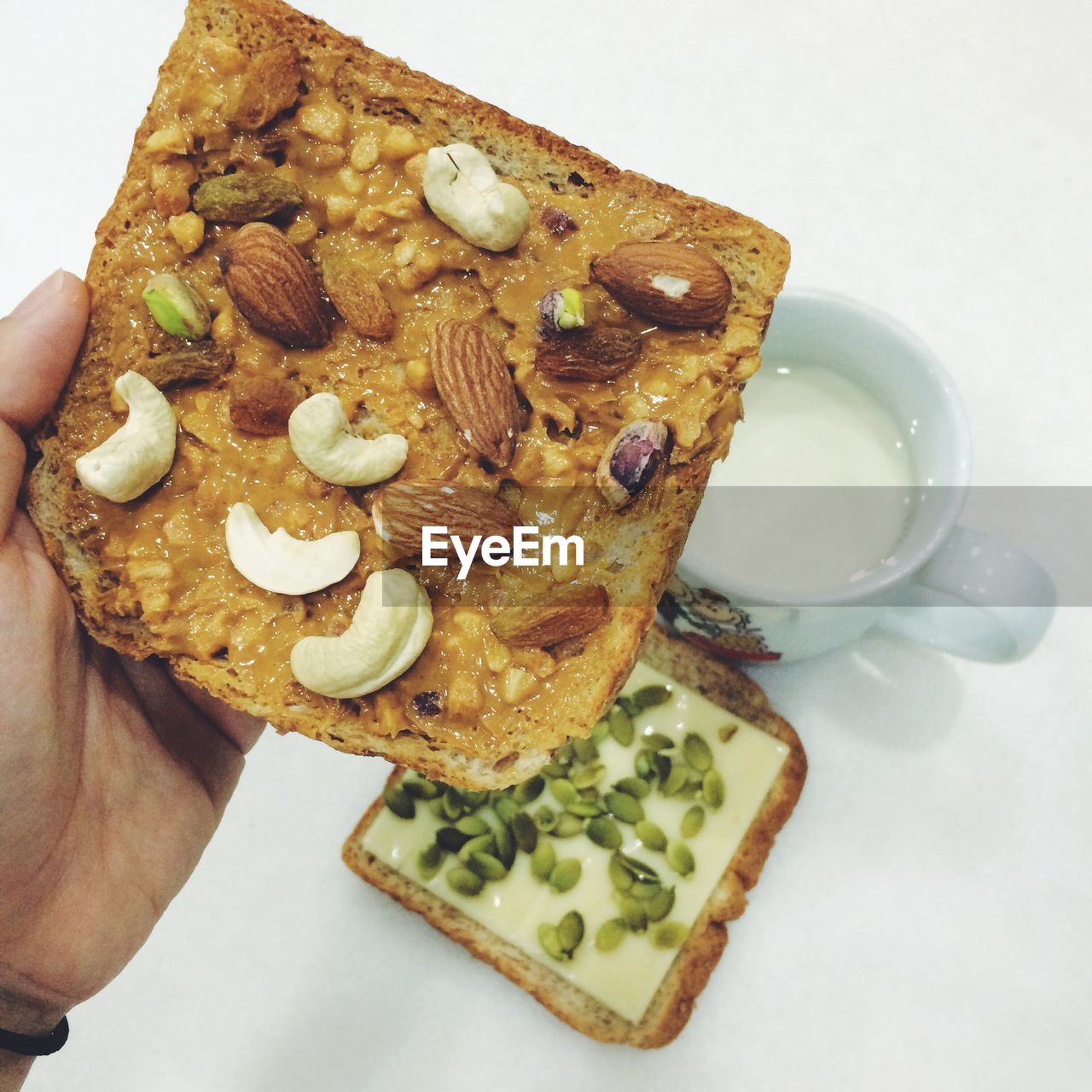 Close-up of hand holding a bread in breakfast