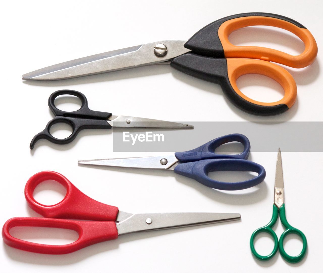 High angle view of colorful scissors over white background