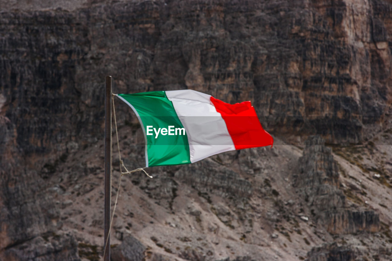 Italian flag waving against mountain