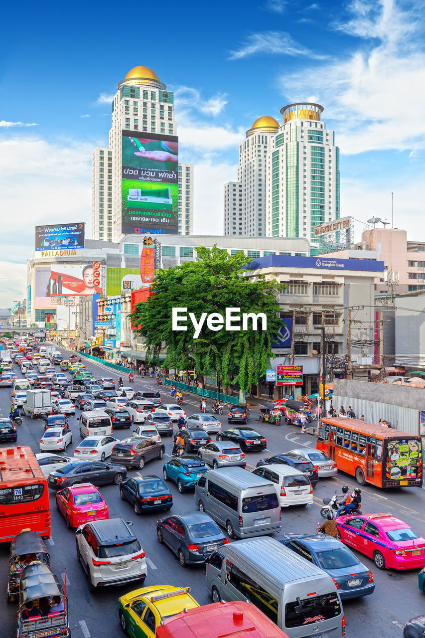 View of city street and buildings against sky
