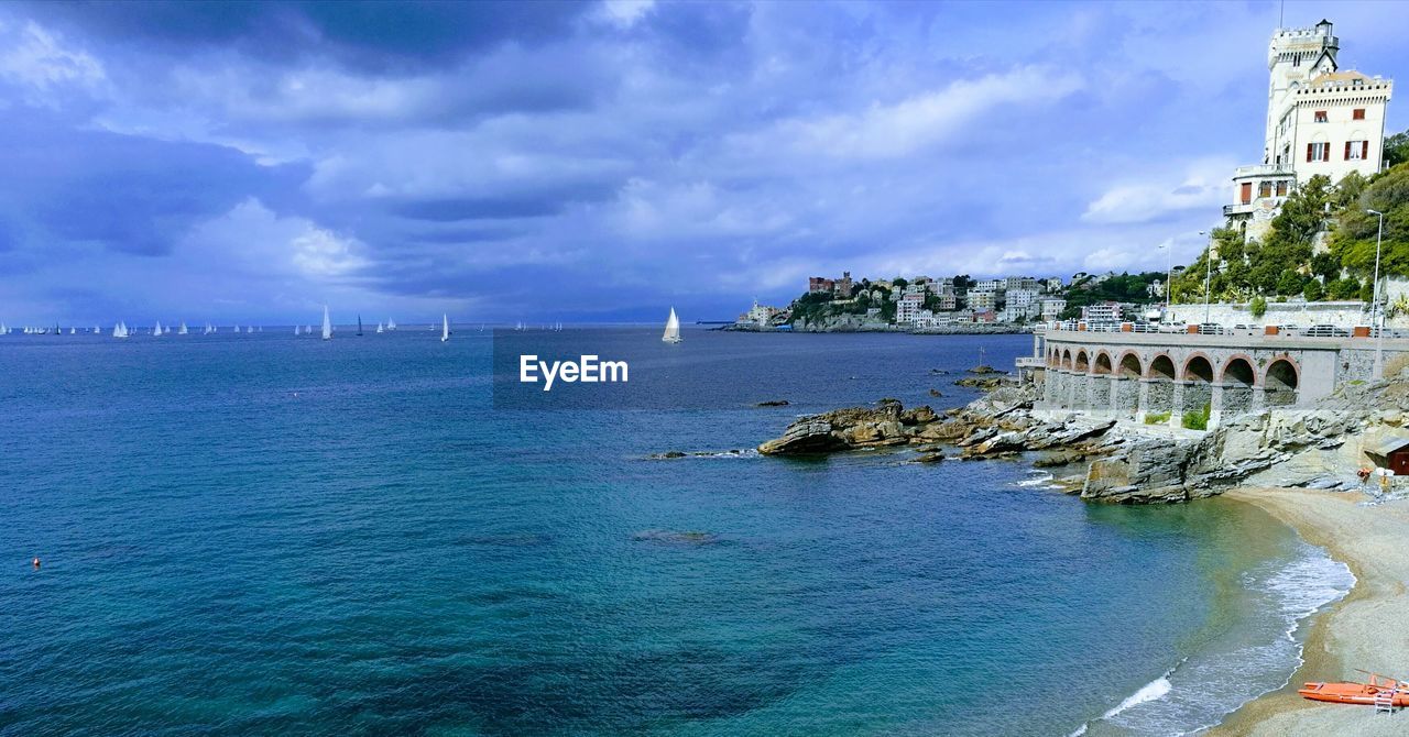 VIEW OF BUILDINGS AGAINST CLOUDY SKY