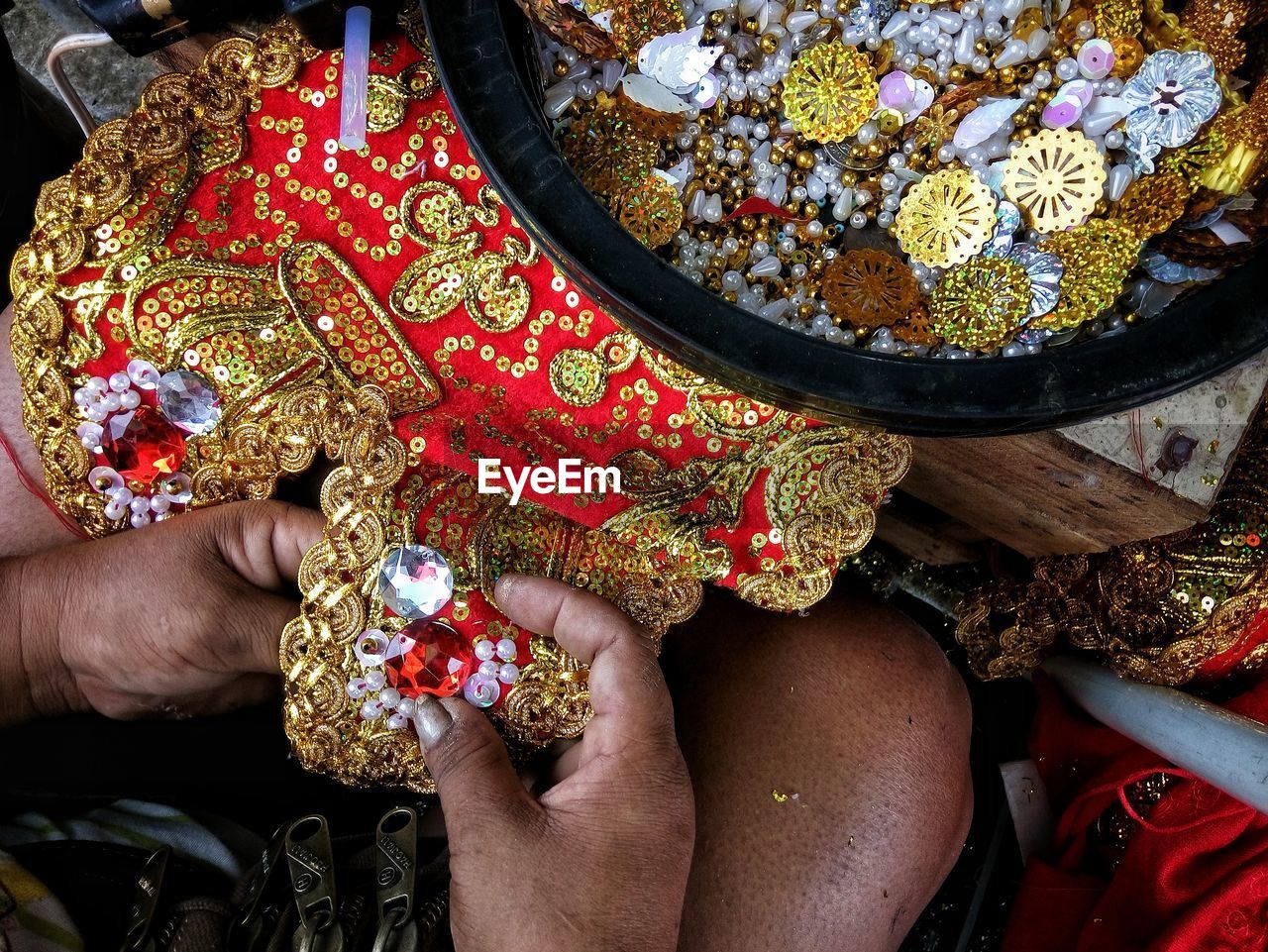 Cropped hands of woman embroidering fabric