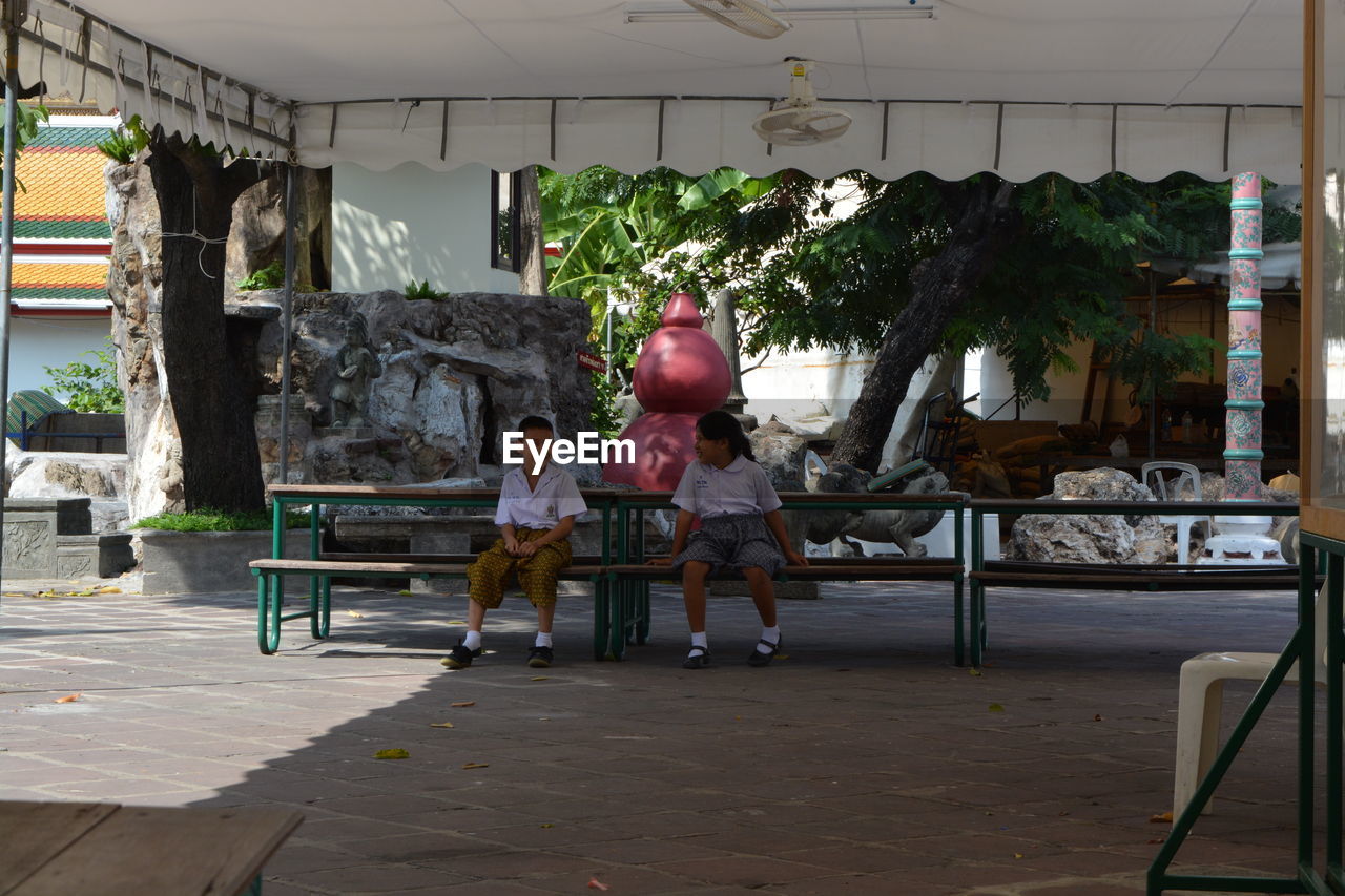 WOMAN SITTING ON CHAIR