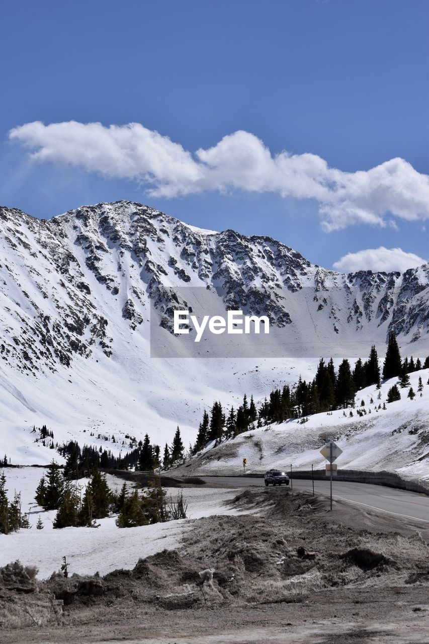 Scenic view of snow covered mountains against sky