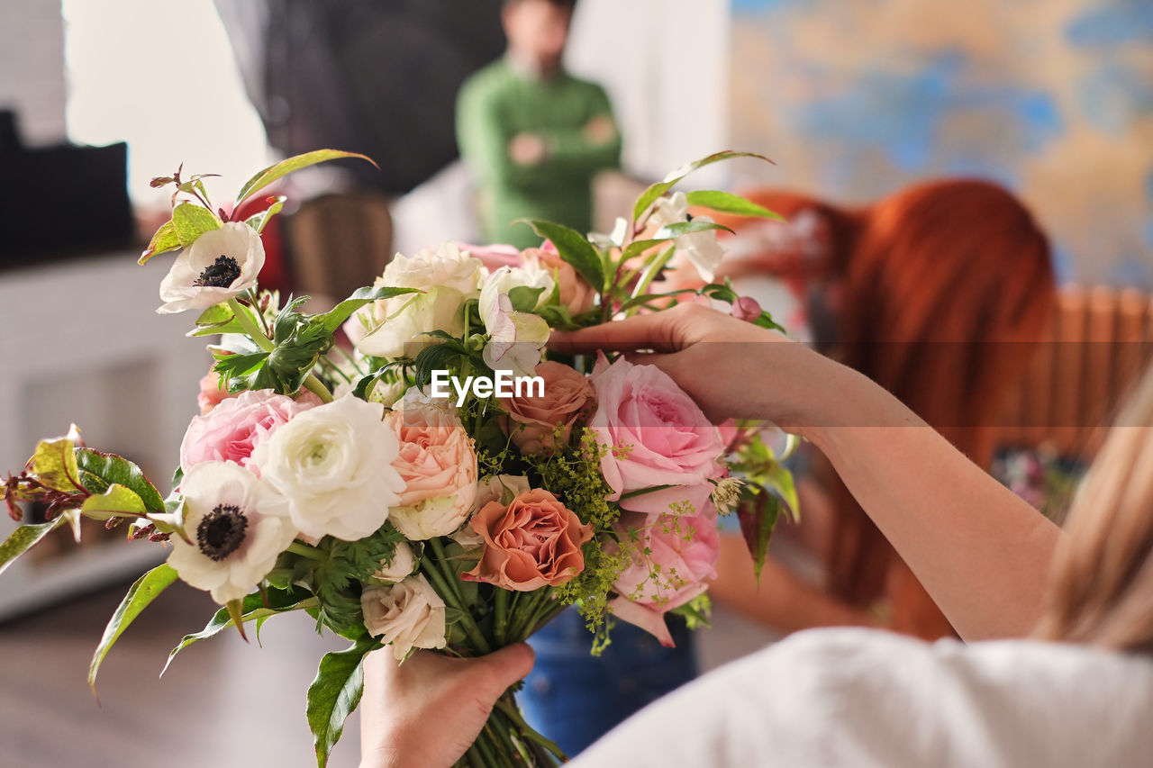 Midsection of woman holding flower bouquet