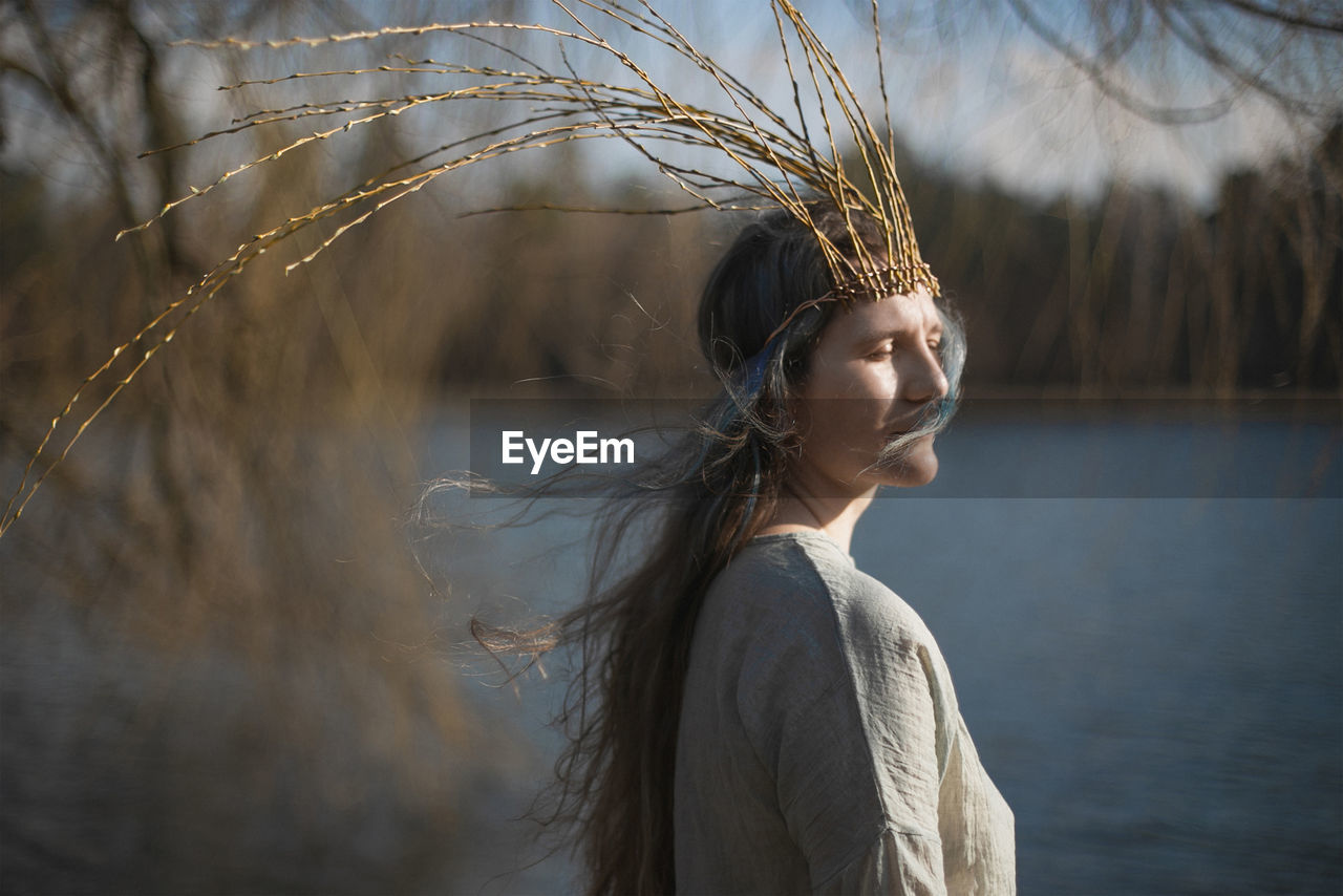 Close up adult lady with willow crown enjoying breeze portrait picture