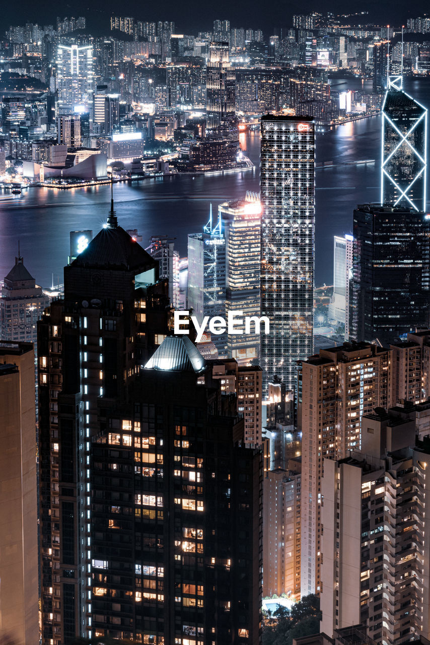 HIGH ANGLE VIEW OF BUILDINGS IN CITY AT NIGHT