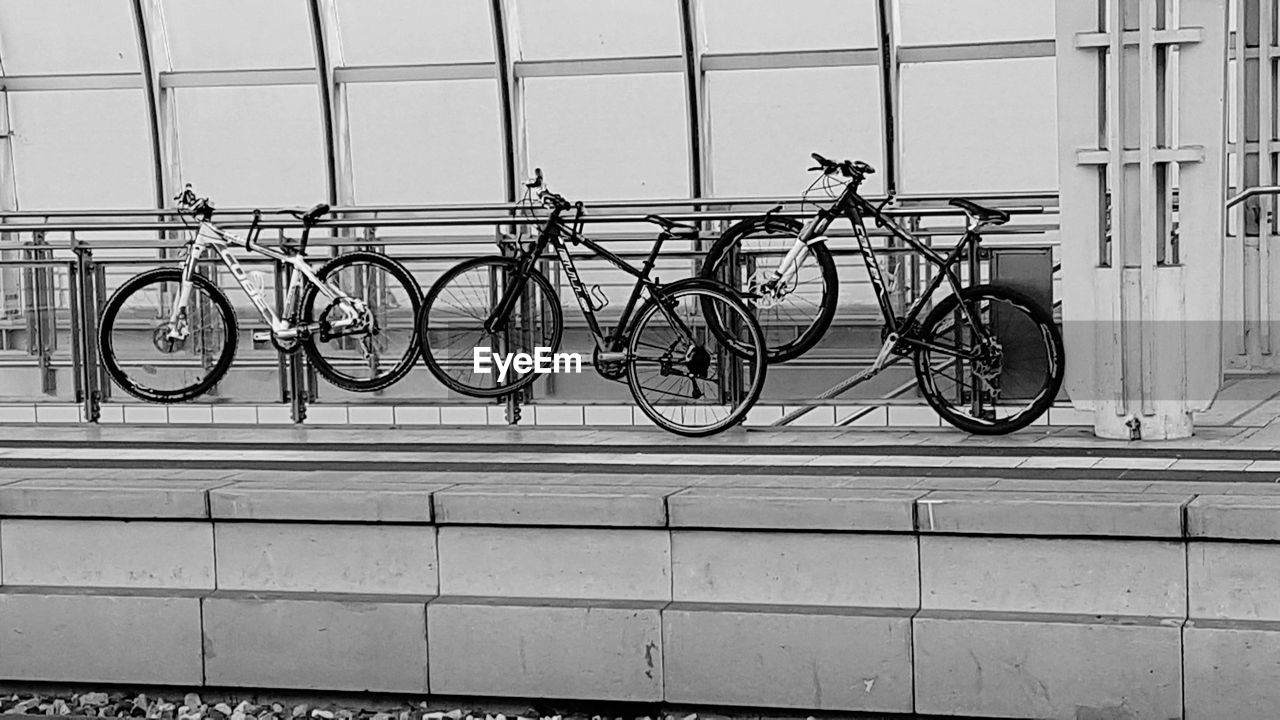 BICYCLES PARKED AGAINST WALL