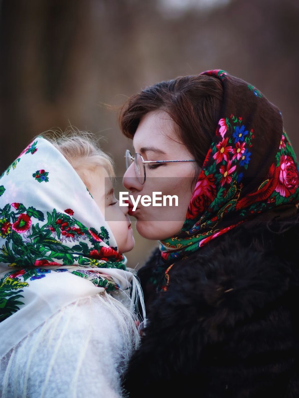 PORTRAIT OF WOMAN WITH DAUGHTER IN SNOW