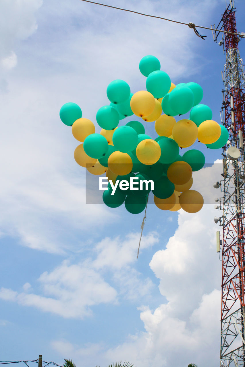 LOW ANGLE VIEW OF BALLOONS AGAINST BLUE SKY