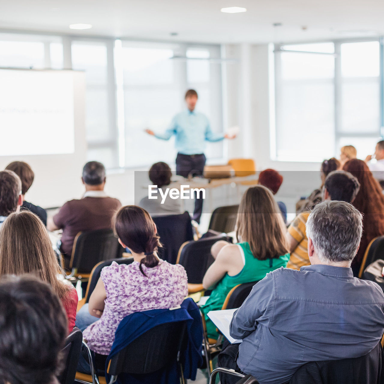 group of people, adult, women, learning, men, education, student, sitting, crowd, indoors, communication, large group of people, female, talking, school, meeting, teacher, seminar, discussion, classroom, listening, university student, young adult, university, togetherness, mature adult, teaching, standing, class, lecture hall, teenager, group, professor, audience, child, candid, business conference, rear view, architecture, explaining, leadership, business meeting, adult student, business, looking, conference, table, convention center