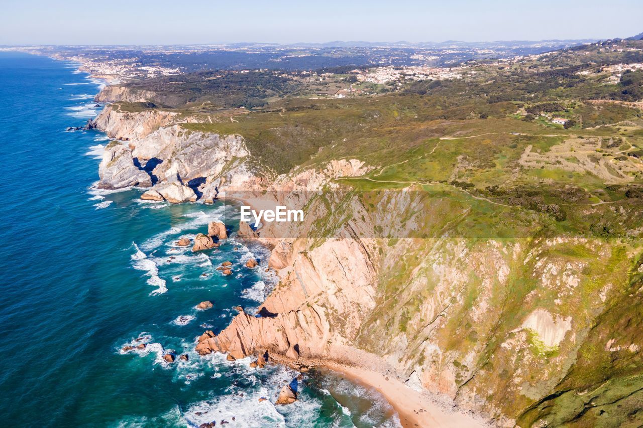 HIGH ANGLE VIEW OF ROCKS ON SEA SHORE