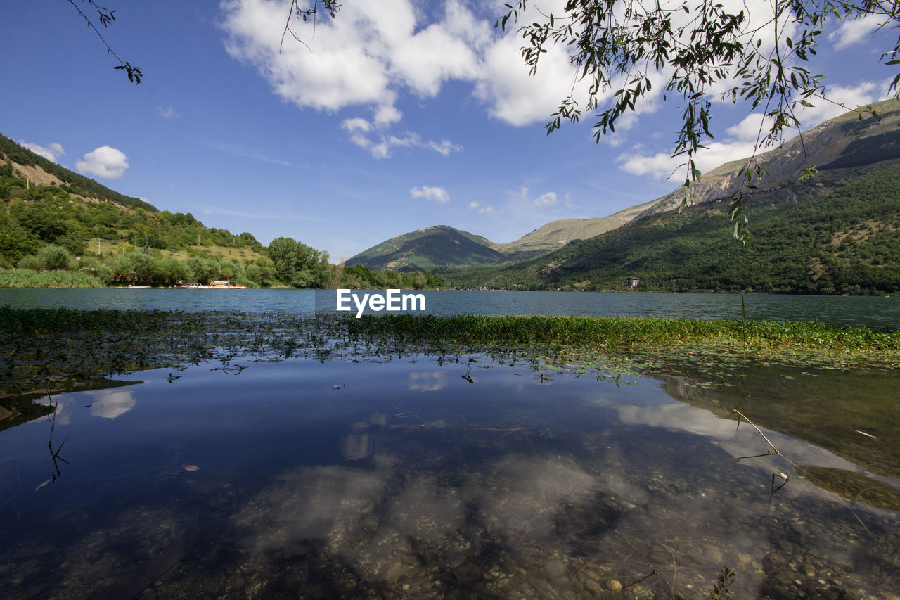 Scenic view of lake and mountains against sky