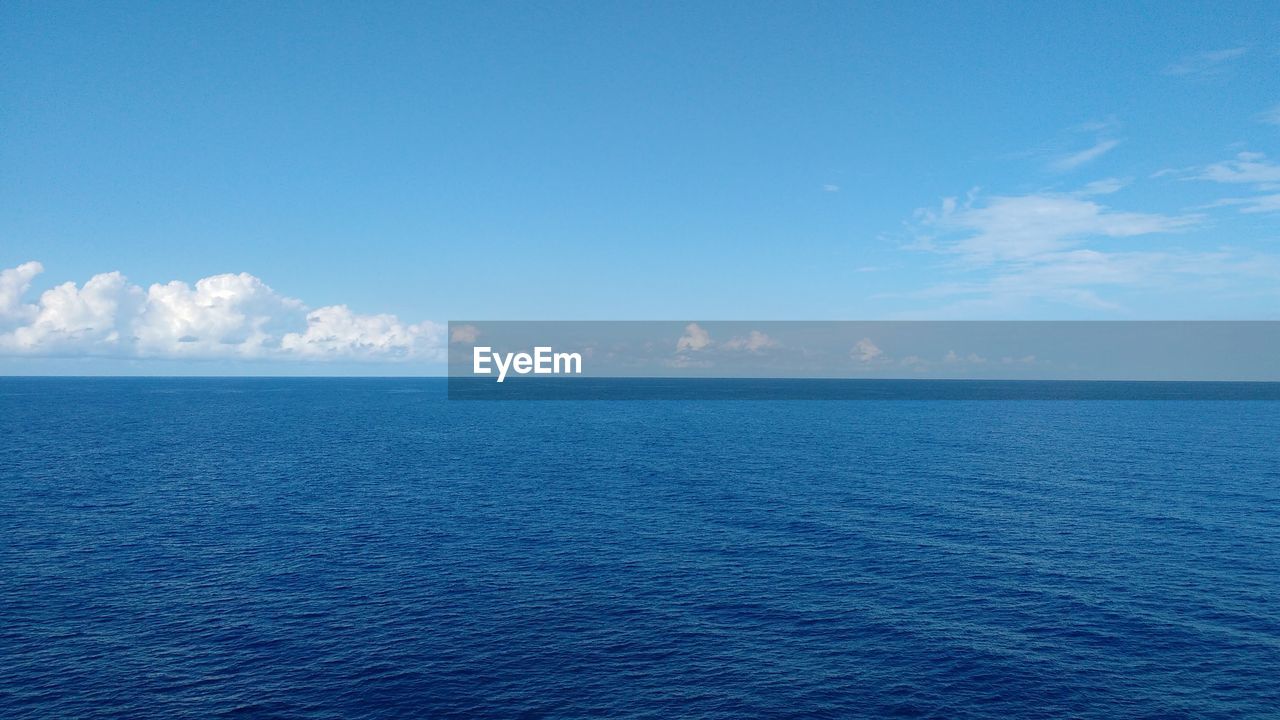 Scenic view of sea against blue sky