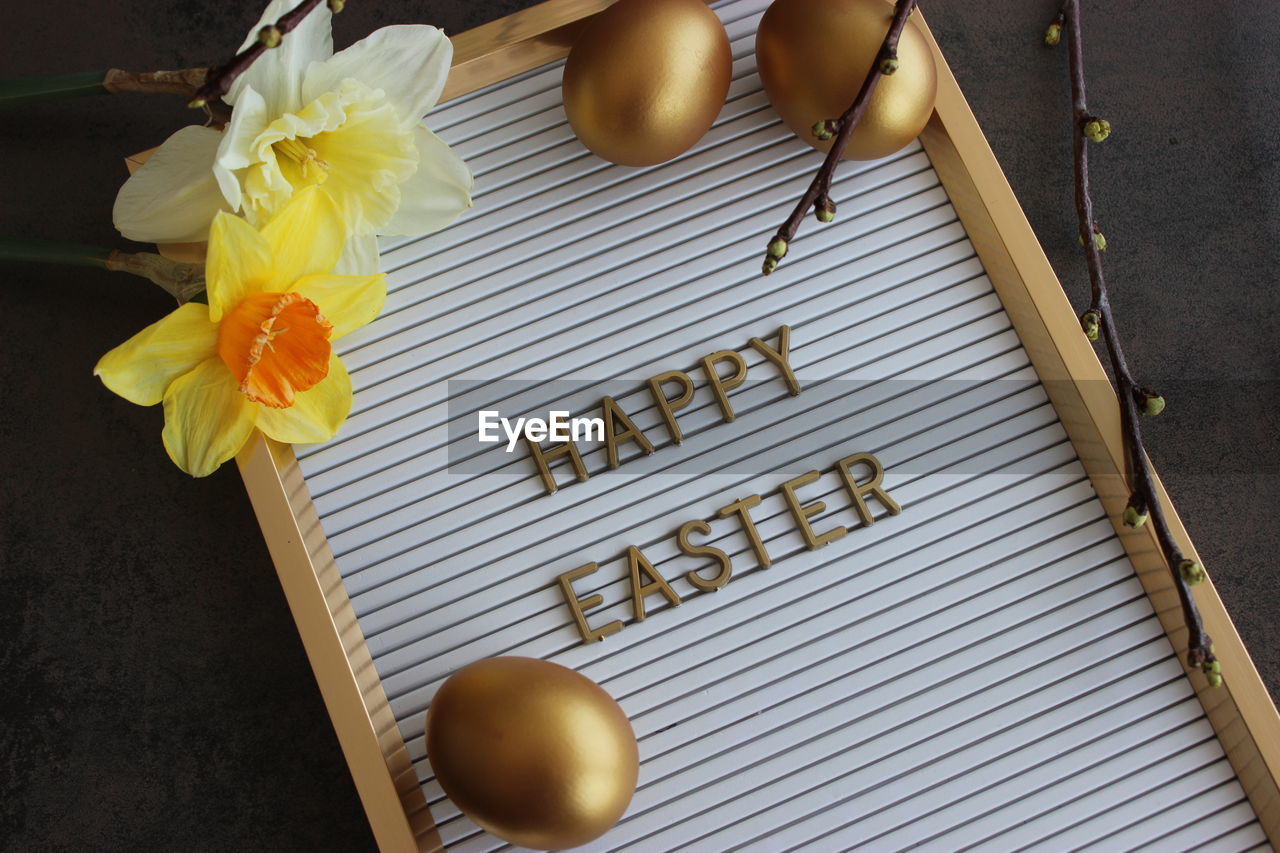 High angle view of letter board with easter accessoires 