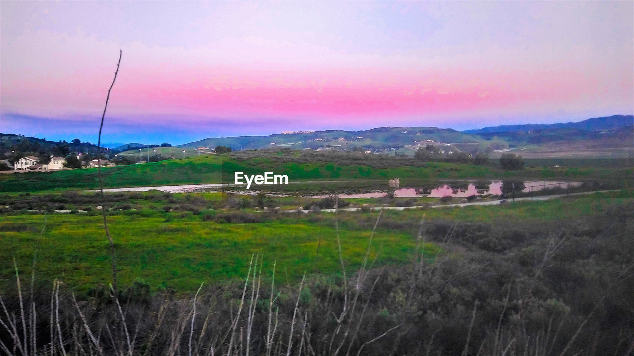 SCENIC VIEW OF LANDSCAPE AGAINST SKY DURING SUNSET