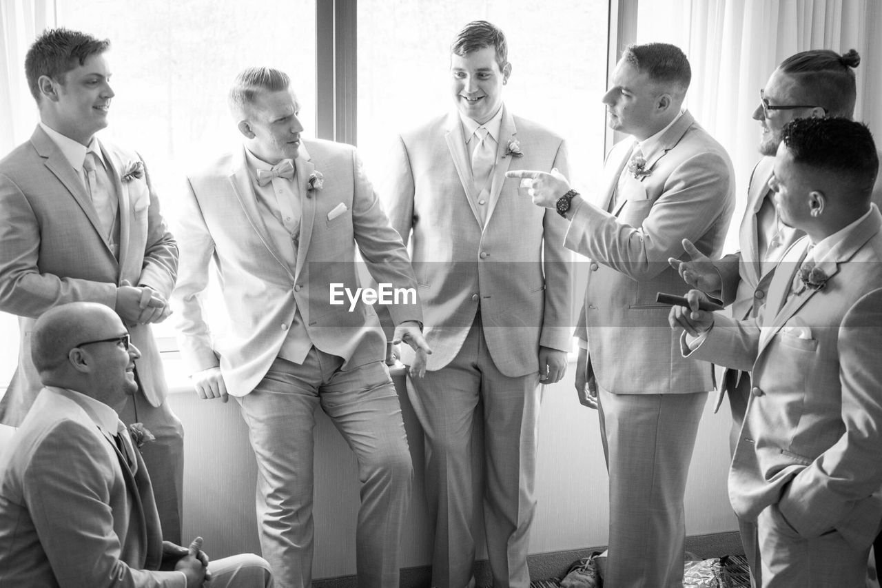 Groomsmen talking during wedding