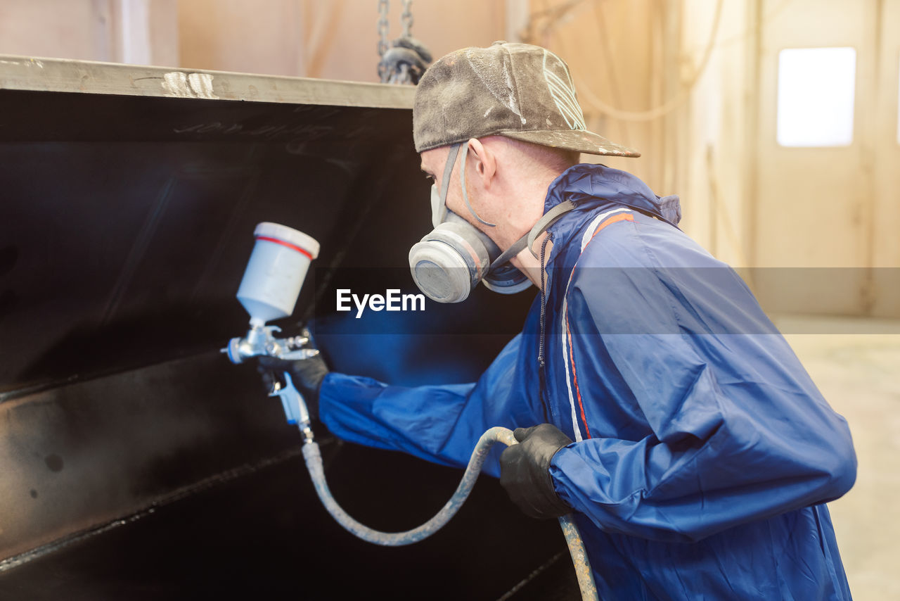 Side view of man working in workshop