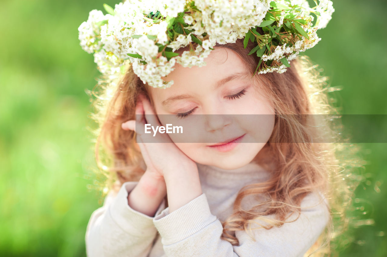 Close-up of girl wearing wreath at park