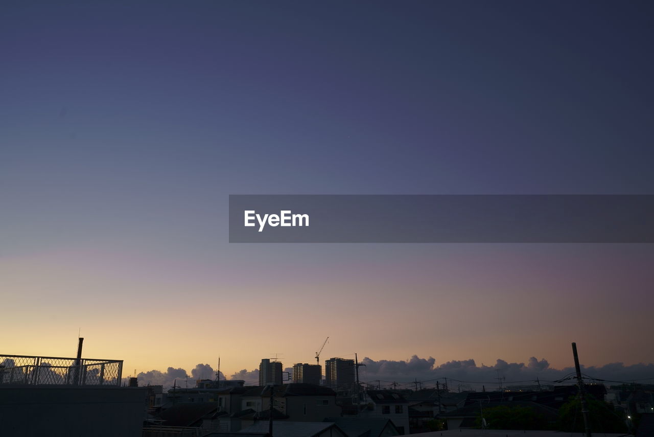 SILHOUETTE BUILDINGS AGAINST SKY AT SUNSET