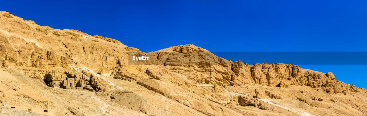 Scenic view of mountains against clear blue sky