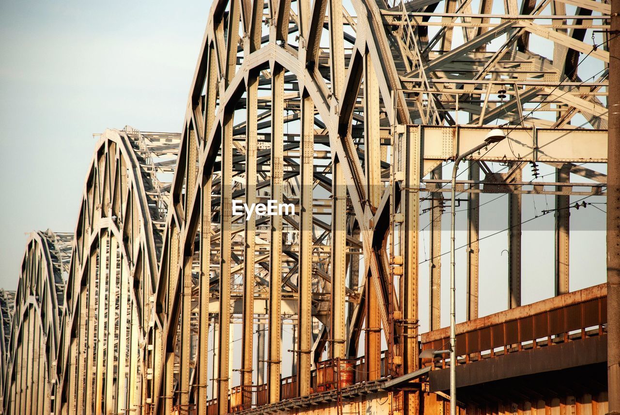 Low angle view of steel bridge over daugava river in riga, latvia