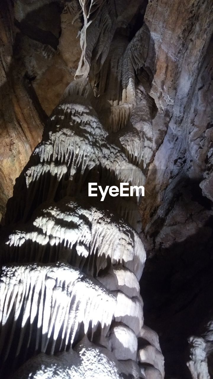 LOW ANGLE VIEW OF ROCK FORMATIONS IN CAVE