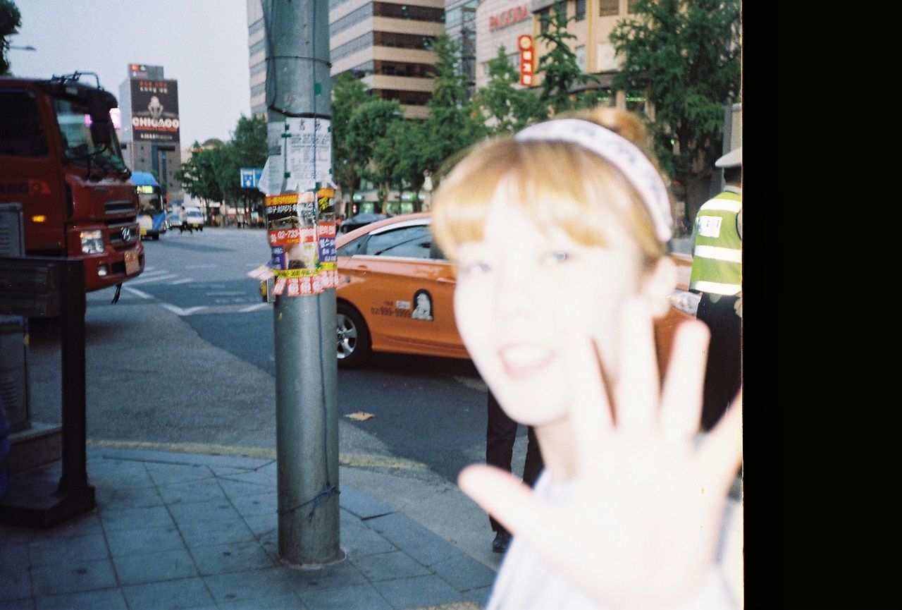 YOUNG WOMAN STANDING ON STREET