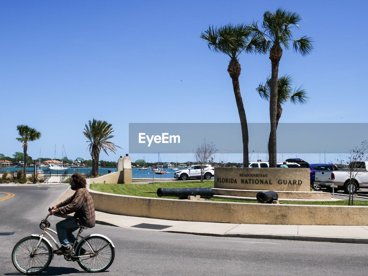 MAN RIDING BICYCLE ON ROAD