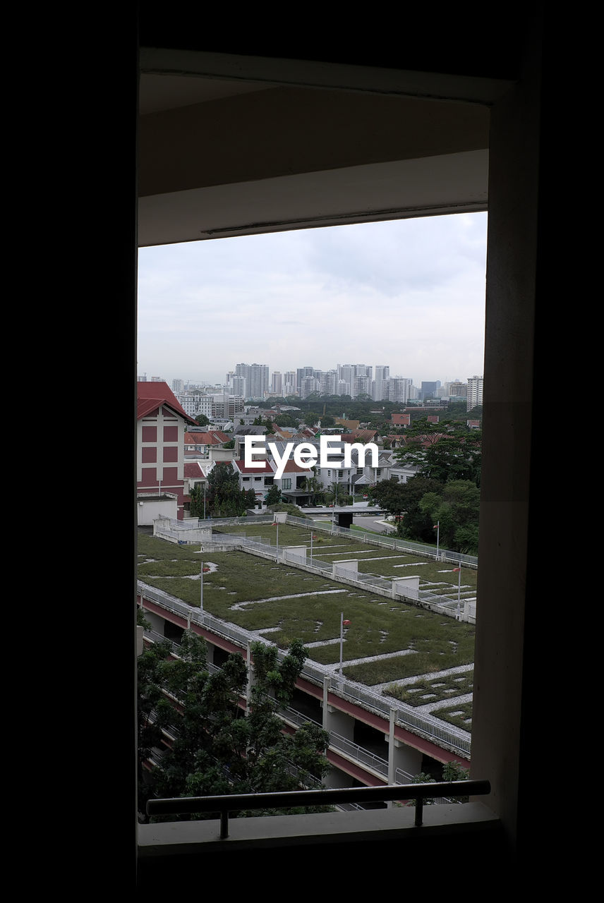 VIEW OF CITYSCAPE SEEN THROUGH WINDOW