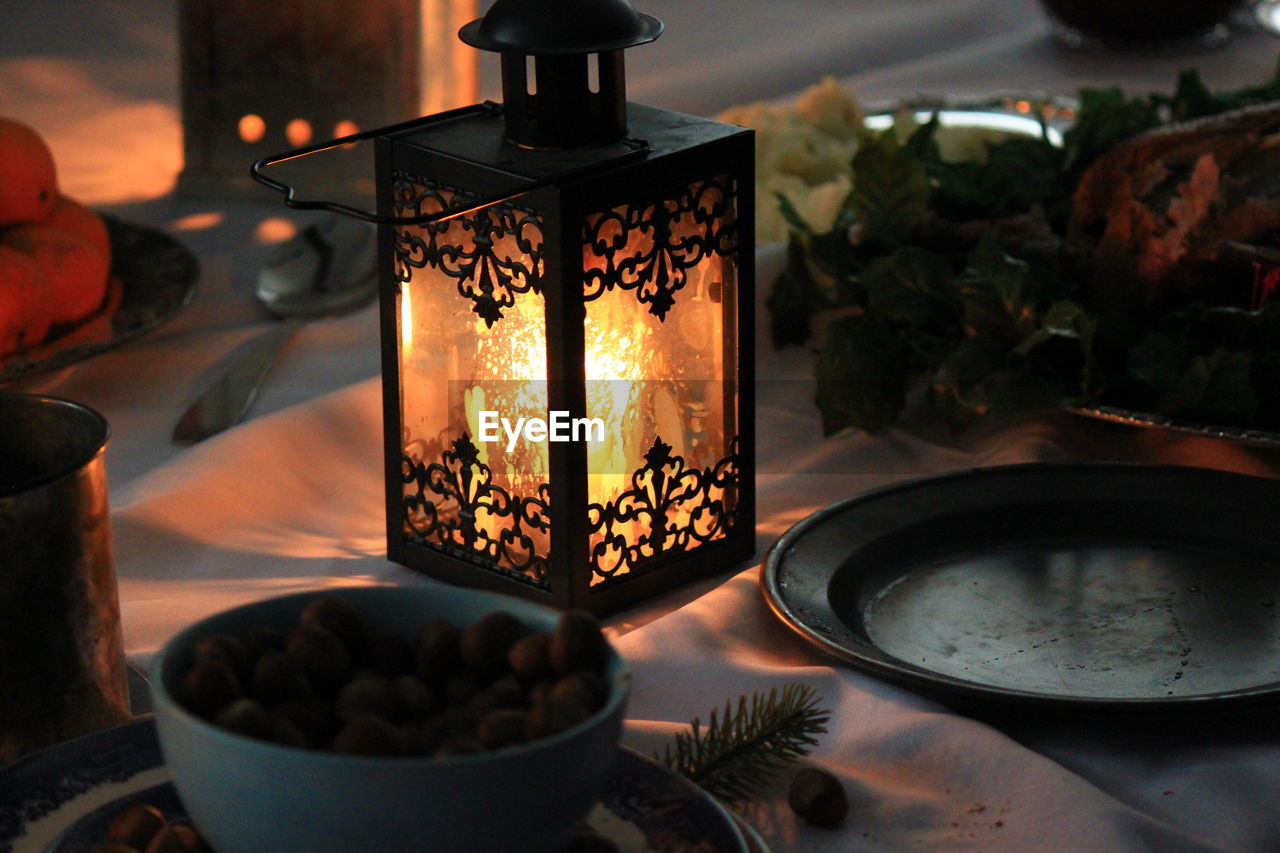 Close-up of illuminated candles on table