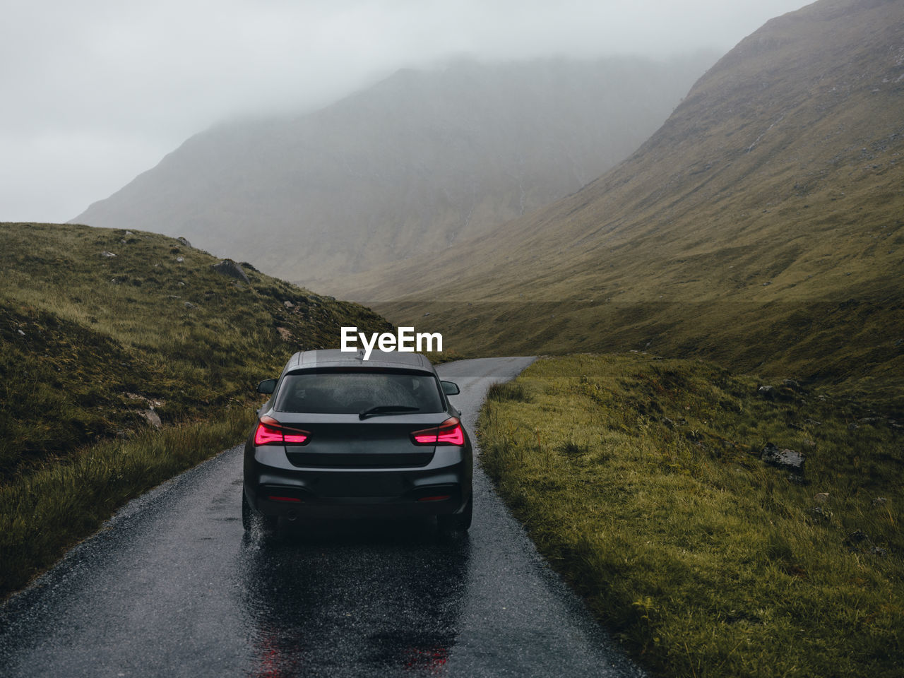 Car driving on road through glen etive