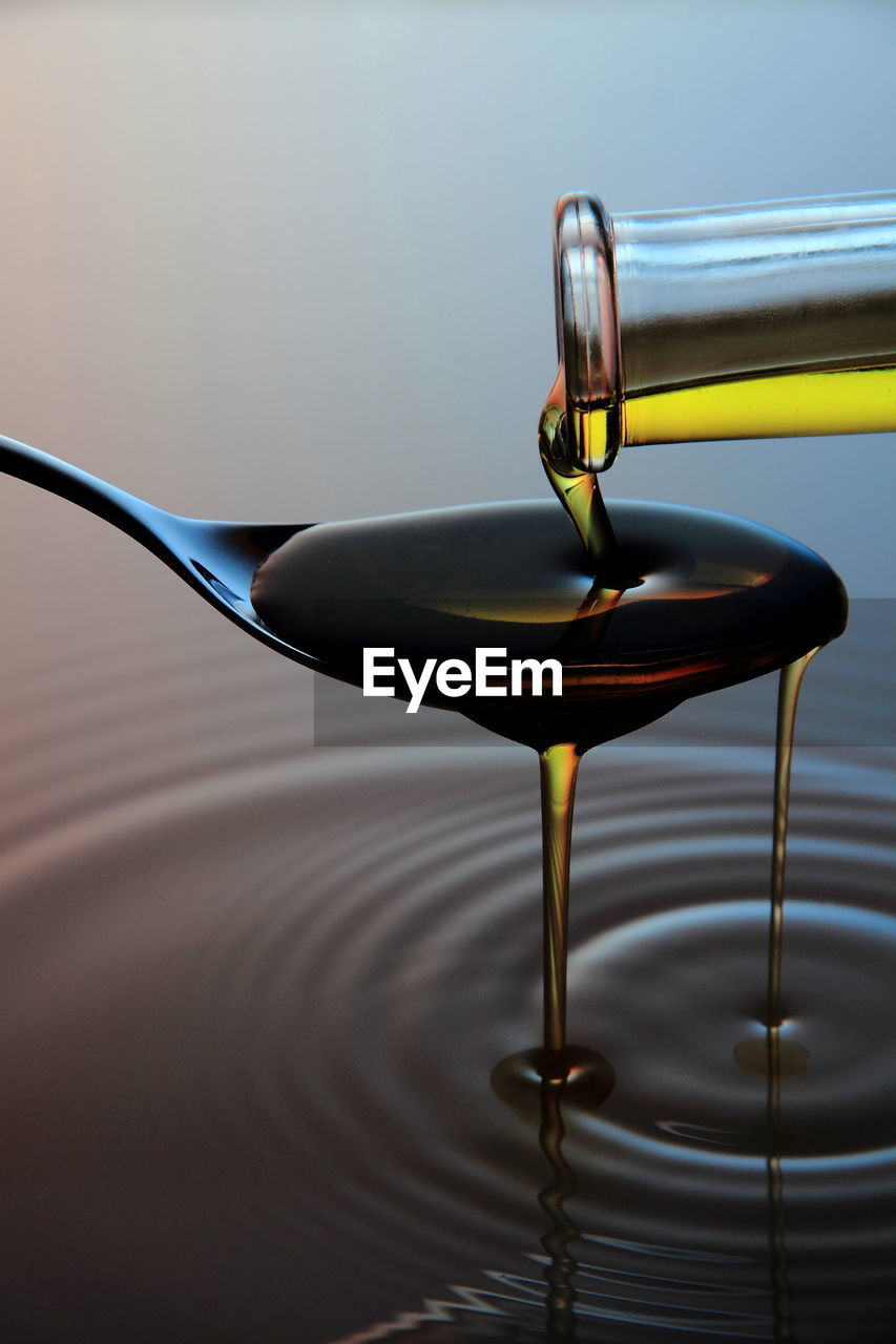 Close-up of oil pouring in spoon