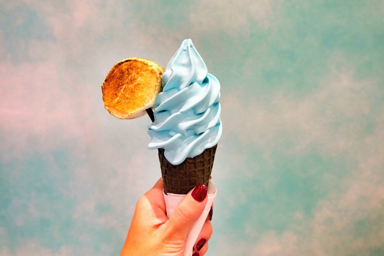 Close-up of hand holding ice cream