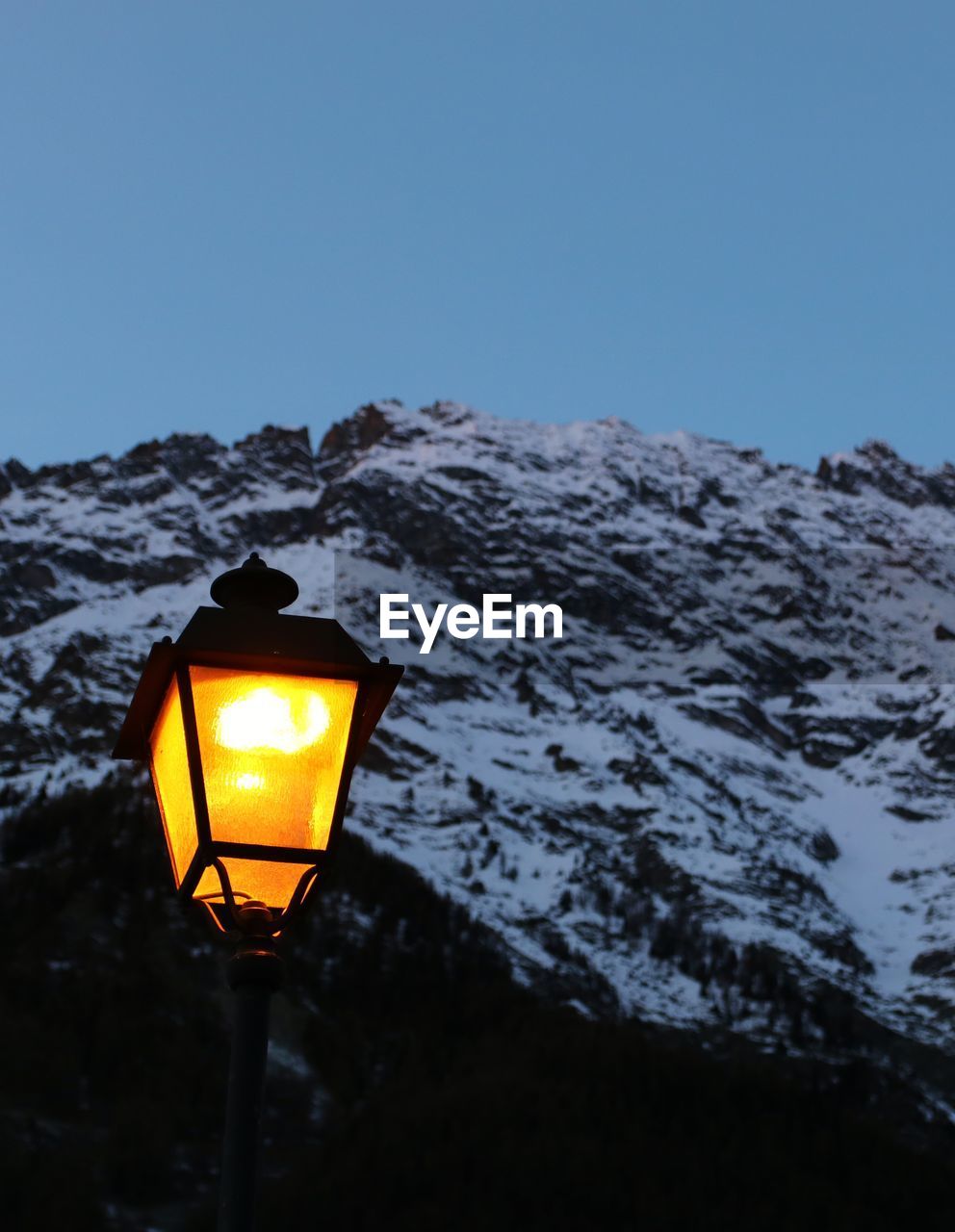 Low angle view of illuminated street light against clear sky