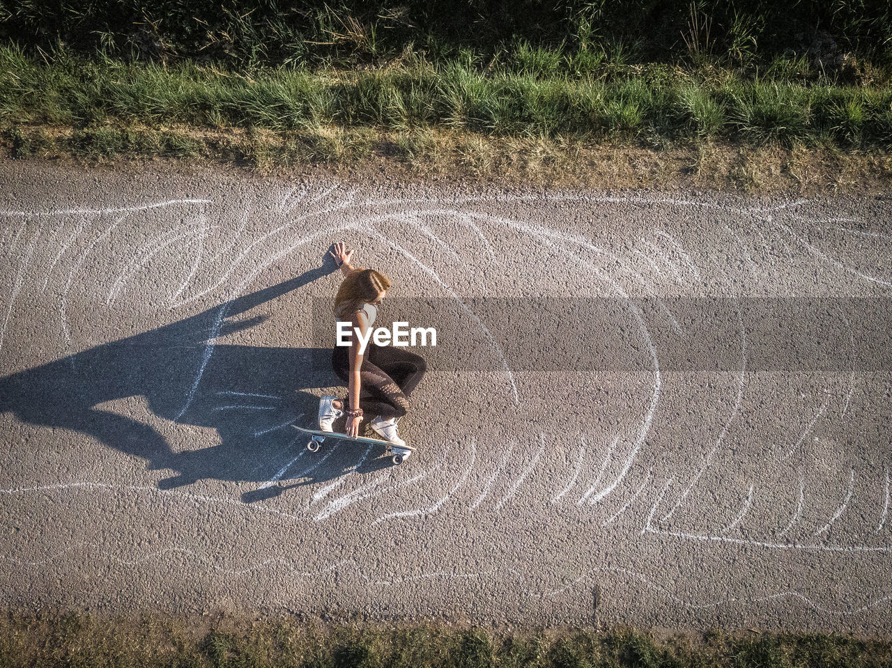 High angle view of woman skateboarding on road