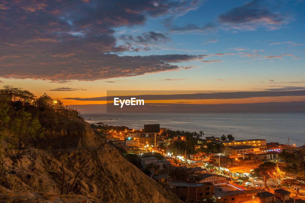 High angle view of illuminated buildings against sky during sunset