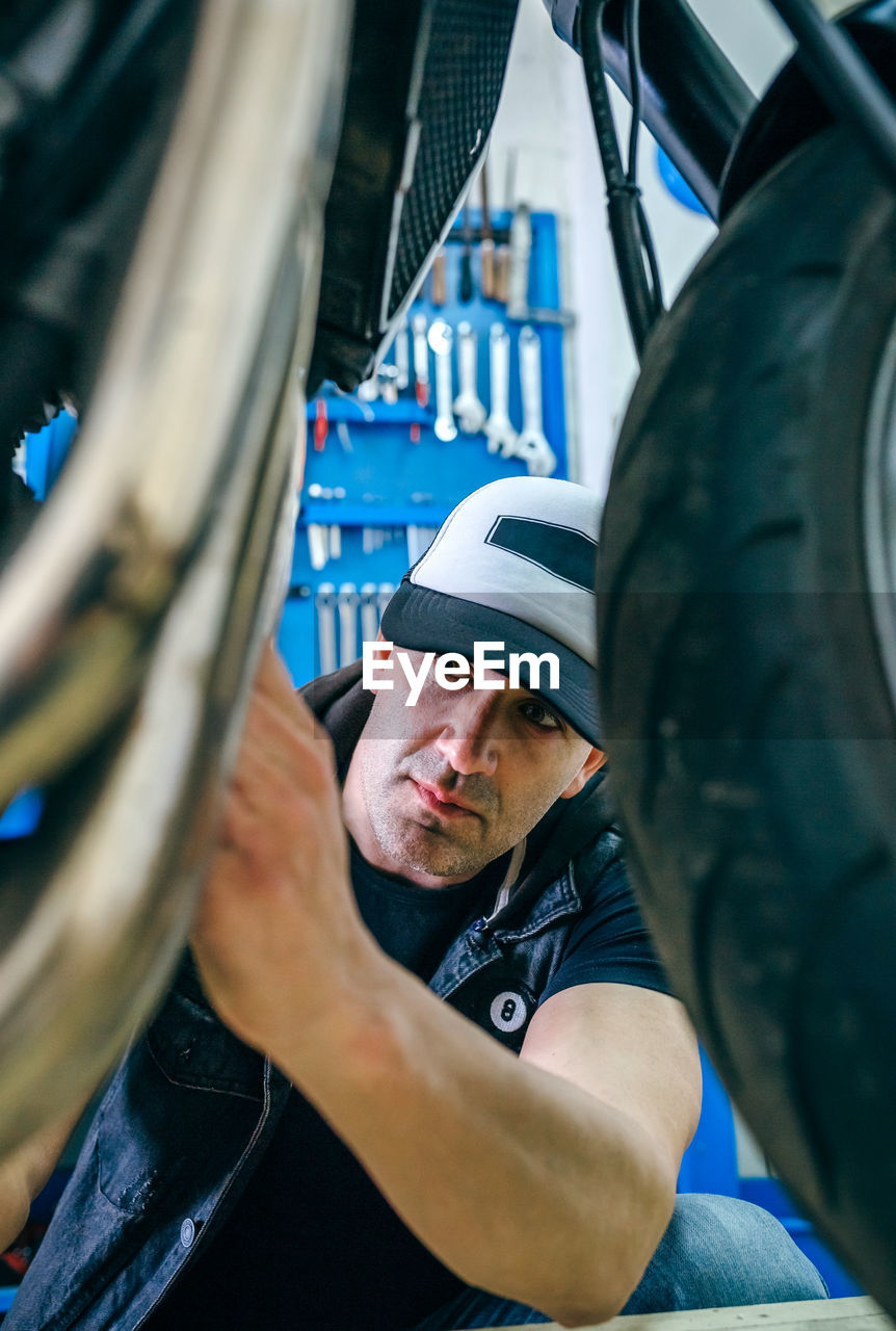 Mechanic repairing motorcycle