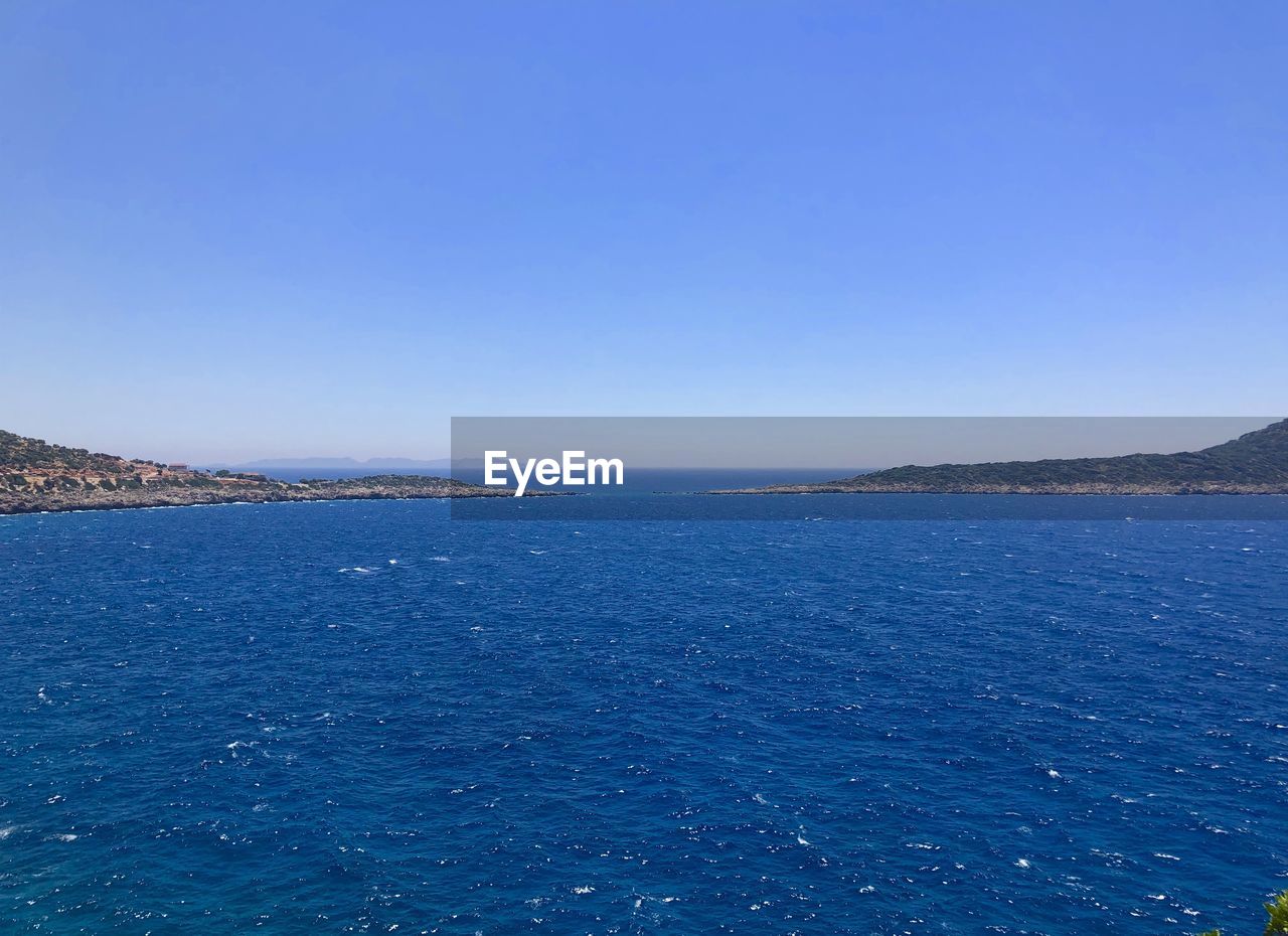 Scenic view of sea against clear blue sky