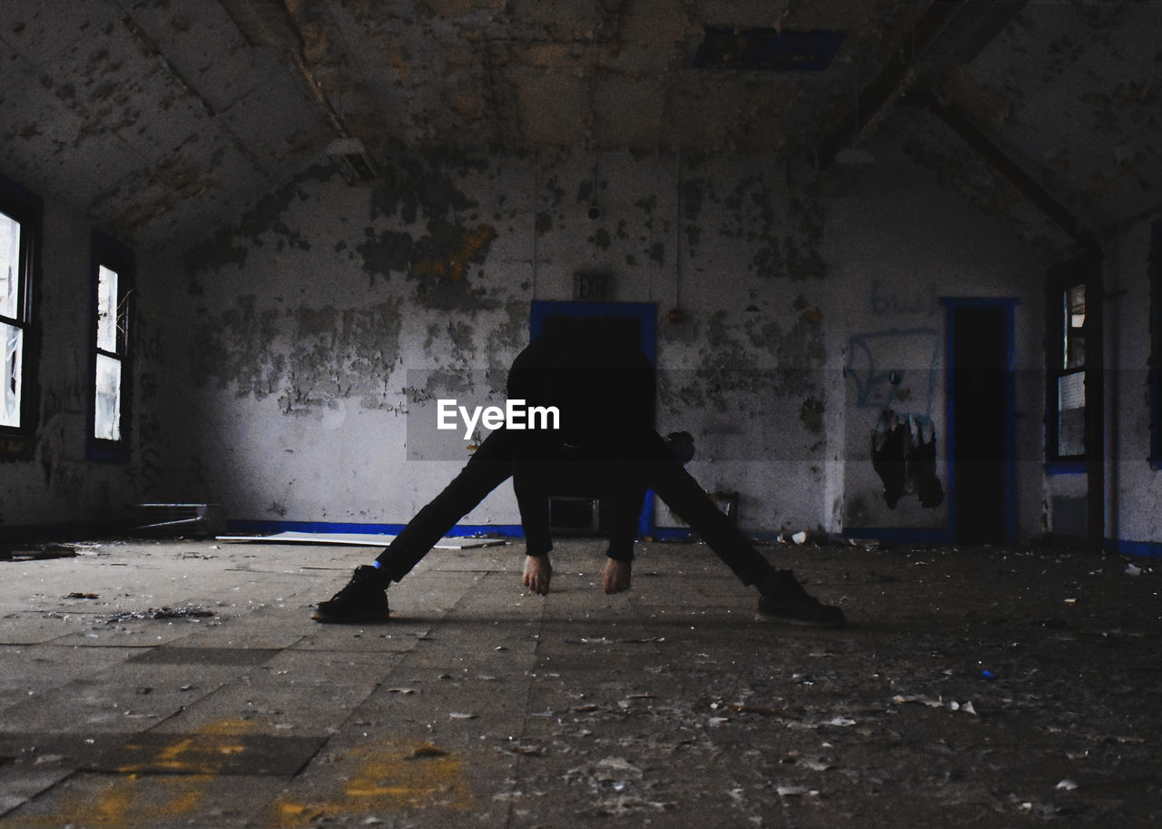 Rear view of person standing in abandoned building