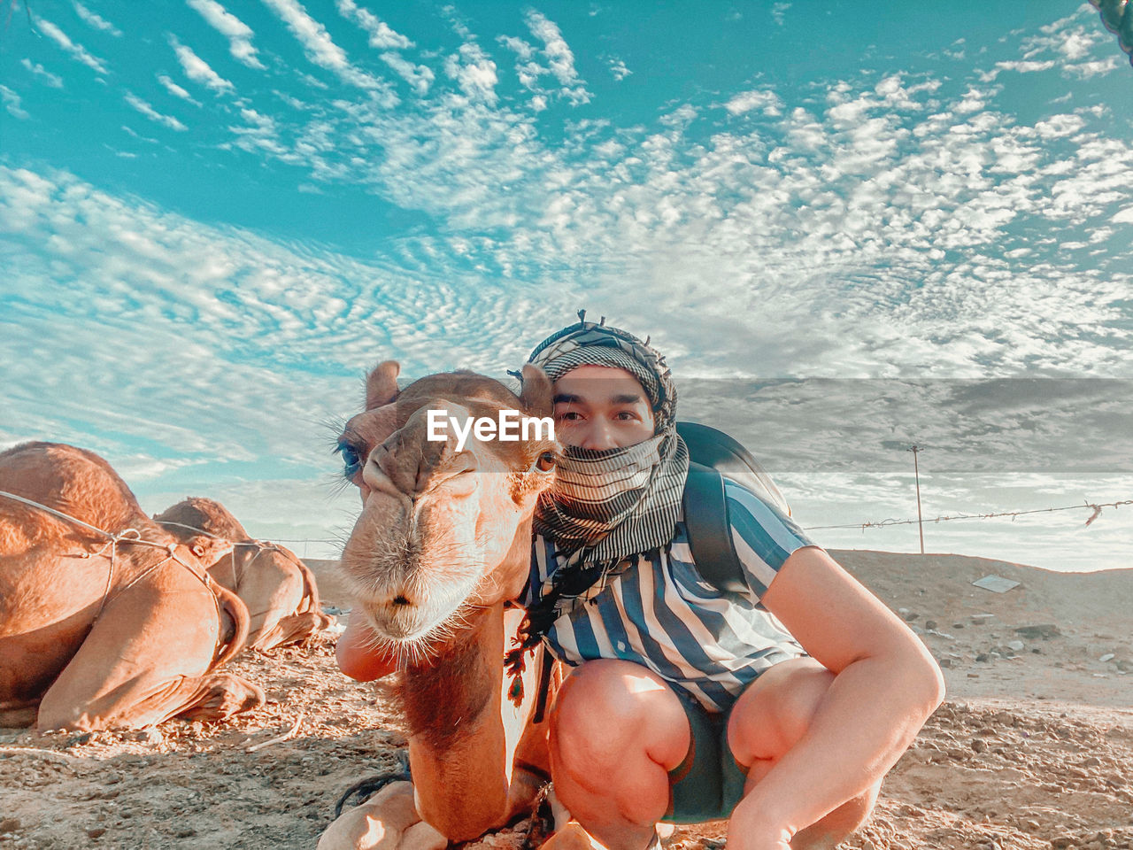 Man with camel at desert 