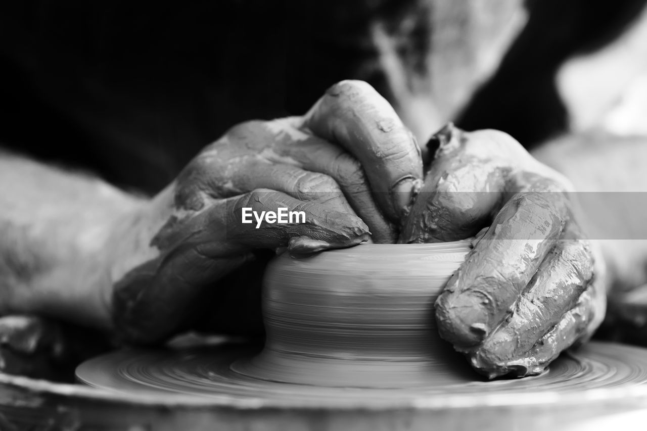 Hands of a potter. potter making ceramic pot on the pottery wheel