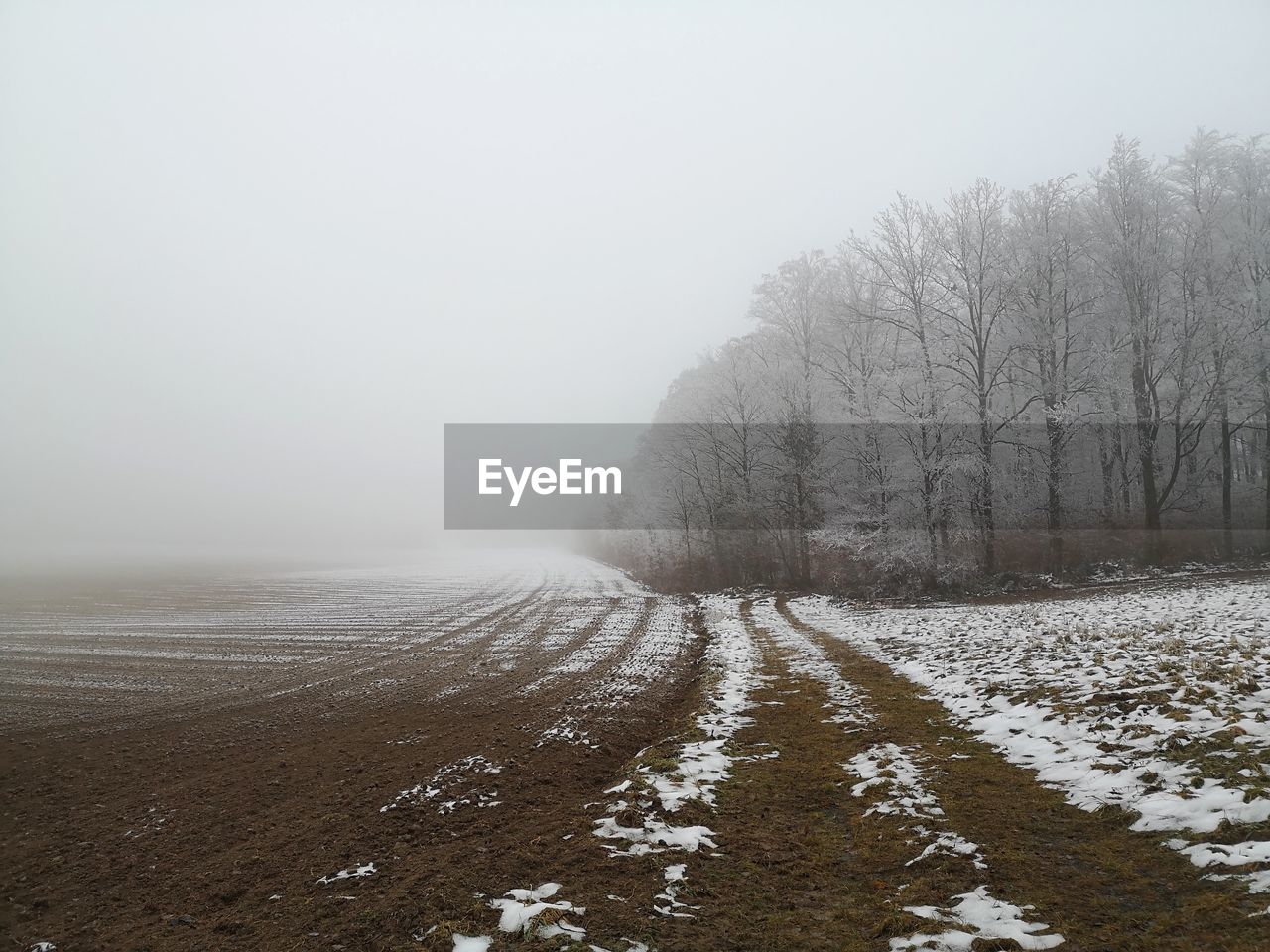 SNOW COVERED LAND AGAINST SKY