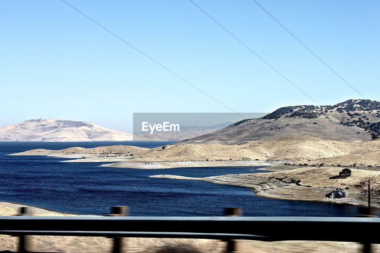 View of san luis reservoir against clear sky