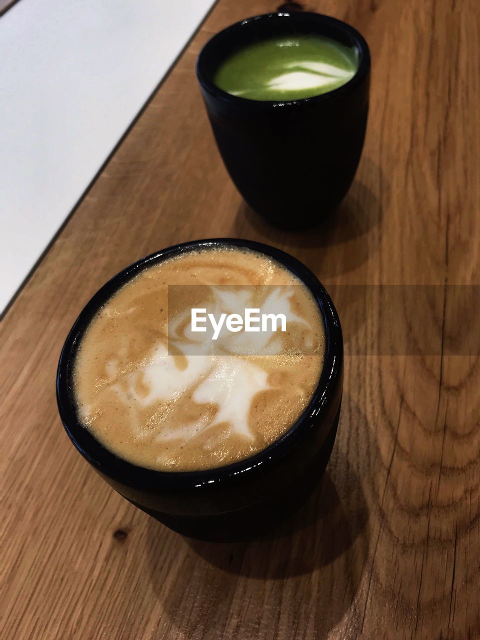 HIGH ANGLE VIEW OF COFFEE IN GLASS ON TABLE