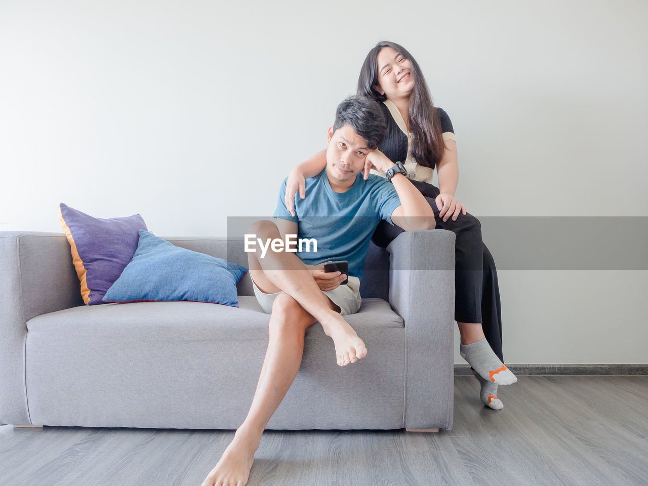 portrait of young woman sitting on sofa